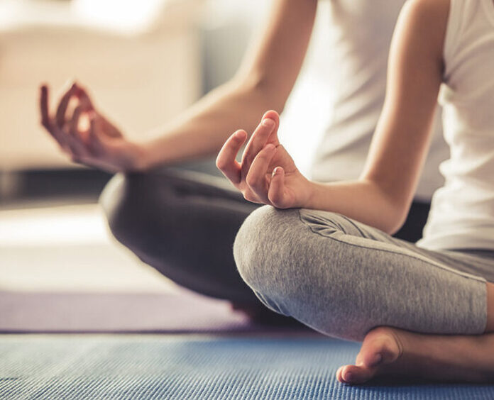 Mom and daughter doing yoga