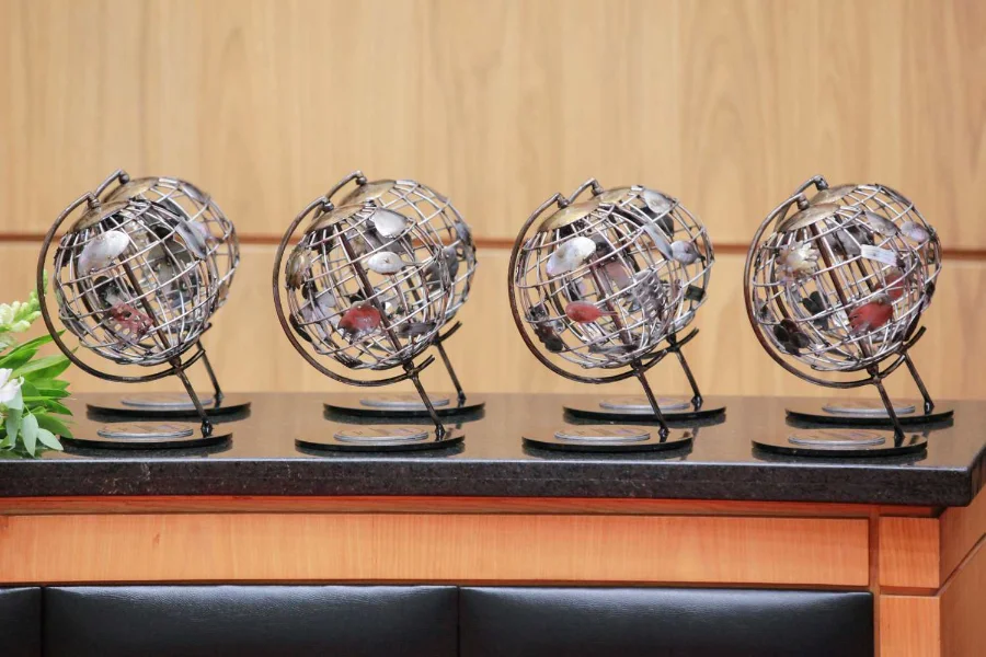 Quatro prêmios (troféus em formato de globo metálico) da Certificação Social da ALESC, dispostos sobre uma bancada antes da cerimônia de premiação.