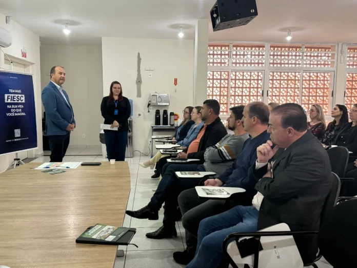 Forquilhinha e FIESC buscam R$ 1 milhão para projeto O vice-presidente da FIESC Regional Sul, Edilson Zanatta, discursando em um púlpito para empresários, durante a Roda de Conversa sobre o Fundo Social e a Lei da Reciclagem em Forquilhinha.