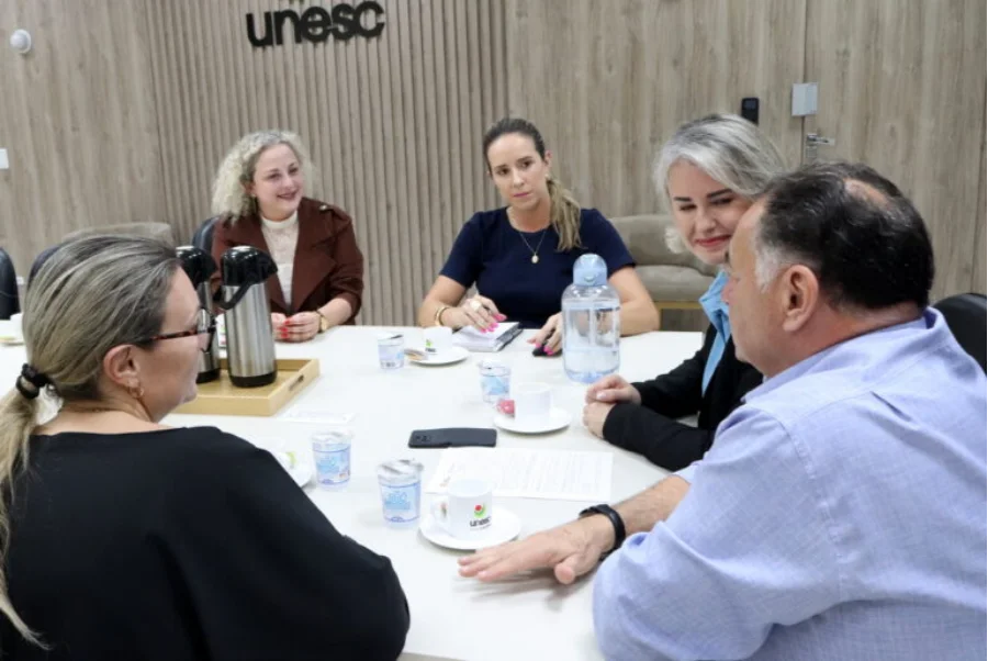 Unesc e Morro da Fumaça articulam parceria para a terceira idade A reitora em exercício da Unesc, Gisele Silveira Coelho Lopes, a primeira-dama Roberta Inocêncio, e a vereadora Marijane Felippe reunidas em uma sala na Unesc, discutindo projetos para a terceira idade.