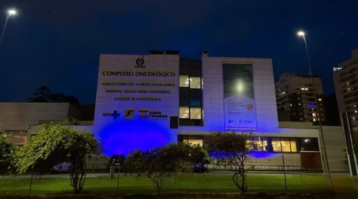 Cepon Cursos de urologia trarão novas tecnologias para SC Fachada do Complexo Oncológico (CEPON) de Florianópolis, iluminada com luzes azuis para o Novembro Azul, simbolizando o avanço da tecnologia e os novos cursos de urologia em Santa Catarina.