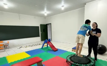 Cocal do Sul inicia grupo de apoio para pais de autistas Criança pulando em trampolim terapêutico, auxiliada por uma terapeuta, em sala com tatames coloridos no novo Centro Terapêutico de Cocal do Sul, que oferece atendimento a pacientes com transtornos do neurodesenvolvimento.