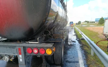Carreta carregada com xarope de glicose pega fogo em Içara Vista traseira de uma carreta tanque preta com pneus queimados e detritos na lateral, após ser atingida por incêndio na BR-101.
