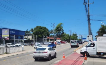 Criciúma libera trincheira e altera trânsito no Rio Maina Carros trafegando em uma avenida (Luiz Lazzarin) em Criciúma, com a trincheira recém-liberada à frente, sob forte sol e céu azul.