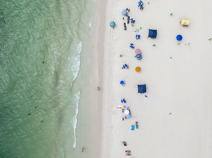 Praia lotada em Santa Catarina no verão. Relatório de balneabilidade do IMA para o final de dezembro de 2025 mostra que a maioria dos pontos monitorados em Florianópolis e no litoral catarinense está apta para banho.
