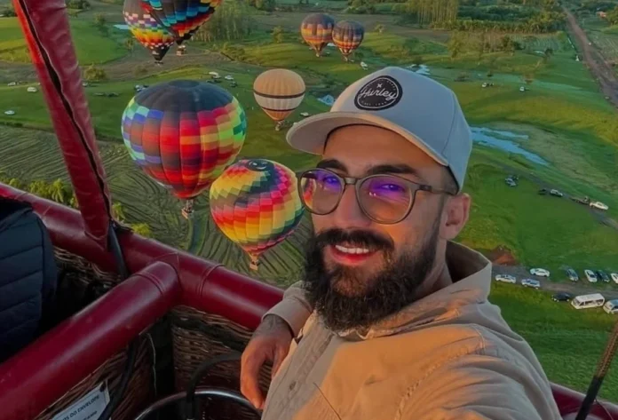 Praia Grande Piloto de balão está desaparecido desde domingo "Cassiano Roldão da Rosa, piloto de balão de Praia Grande, desaparecido desde domingo. Ele usa barba, óculos e boné, e é visto em um balão de ar quente colorido."