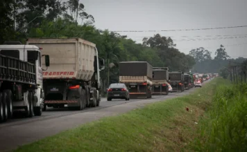 Deputados cobram obras em rodovias federais na Alesc Tráfego intenso de veículos pesados em rodovia federal não duplicada em Santa Catarina, refletindo as cobranças dos deputados por melhorias na infraestrutura viária.