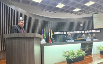 Araranguá planeja rota gastronômica às margens do rio Vereador Juliandro Jacques discursa na tribuna da Câmara de Vereadores de Araranguá sobre a criação da Rota de Lazer e Gastronomia às margens do Rio Araranguá. Ao fundo, painel eletrônico detalha o Anteprojeto de Lei 029/2026 durante a sessão ordinária.