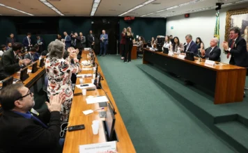 CCJ aprova fim da escala 6×1 e FIESC alerta para riscos Parlamentares na Comissão de Constituição e Justiça (CCJ) da Câmara dos Deputados aplaudem a aprovação de propostas de redução da jornada de trabalho e alteração da escala 6x1, com a presença dos deputados federais Reginaldo Lopes e Tarcísio Motta na mesa principal.