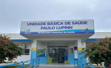 UBS Paulo Lupinn amplia atendimento em Arroio do Silva Fachada da Unidade Básica de Saúde (UBS) Paulo Lupinn, o Posto Central de Balneário Arroio do Silva, mostrando a entrada com rampa de acessibilidade azul, paisagismo e a placa de identificação. A imagem representa o local que passará a ter horário estendido para a saúde do trabalhador.