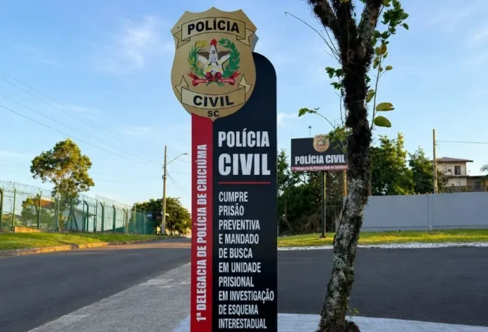 Investigado preso no RS é alvo de apuração por golpes em SC Placa da Polícia Civil em Criciúma informa cumprimento de prisão preventiva e mandado de busca em investigação sobre esquema interestadual de golpes eletrônicos.